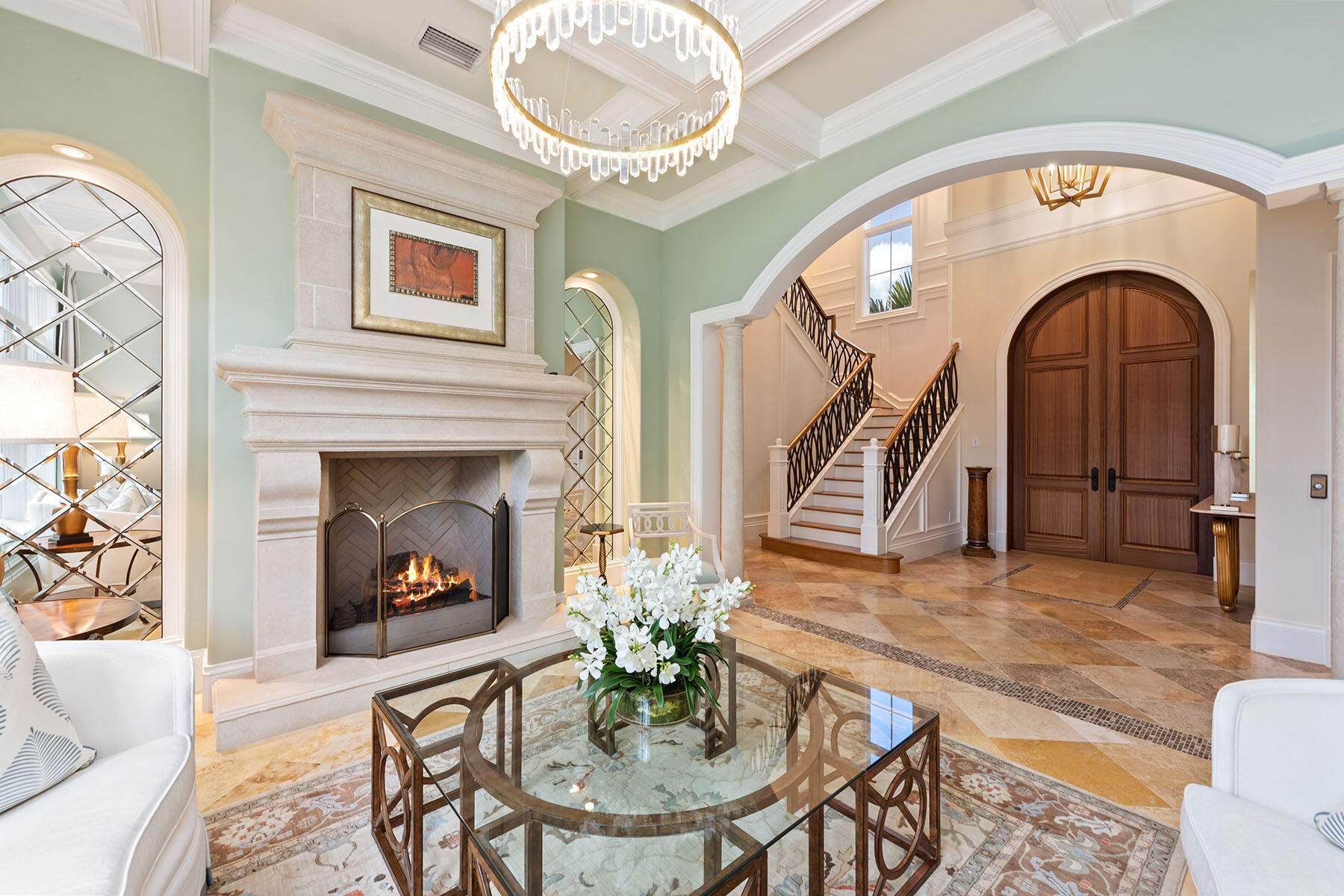3855 Isla Del Sol Way Naples, FL 34114 - Photo 5 of 50 a living room with furniture a mirror and a fireplace