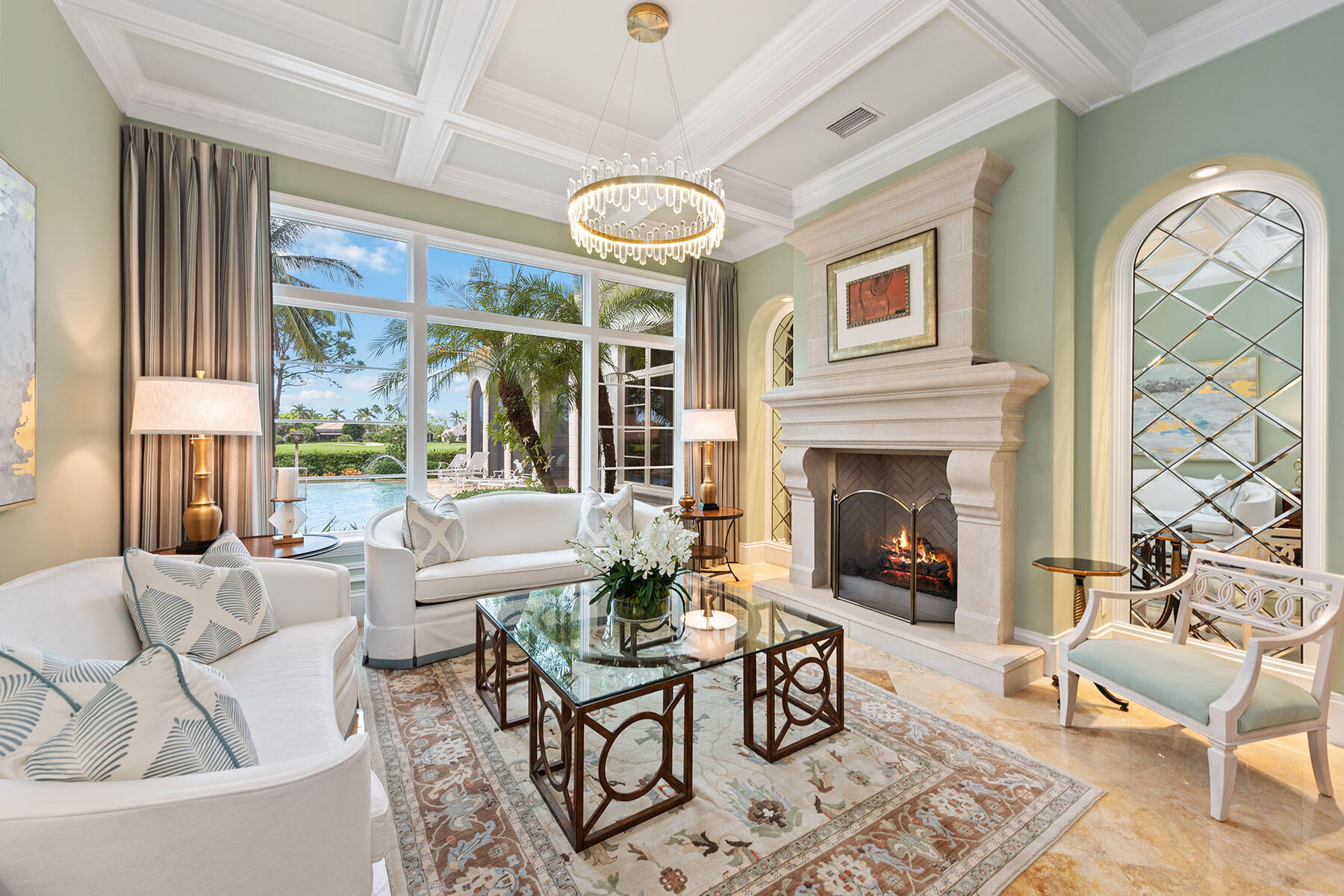 3855 Isla Del Sol Way Naples, FL 34114 - Photo 6 of 50 a living room with furniture a fireplace and a large window