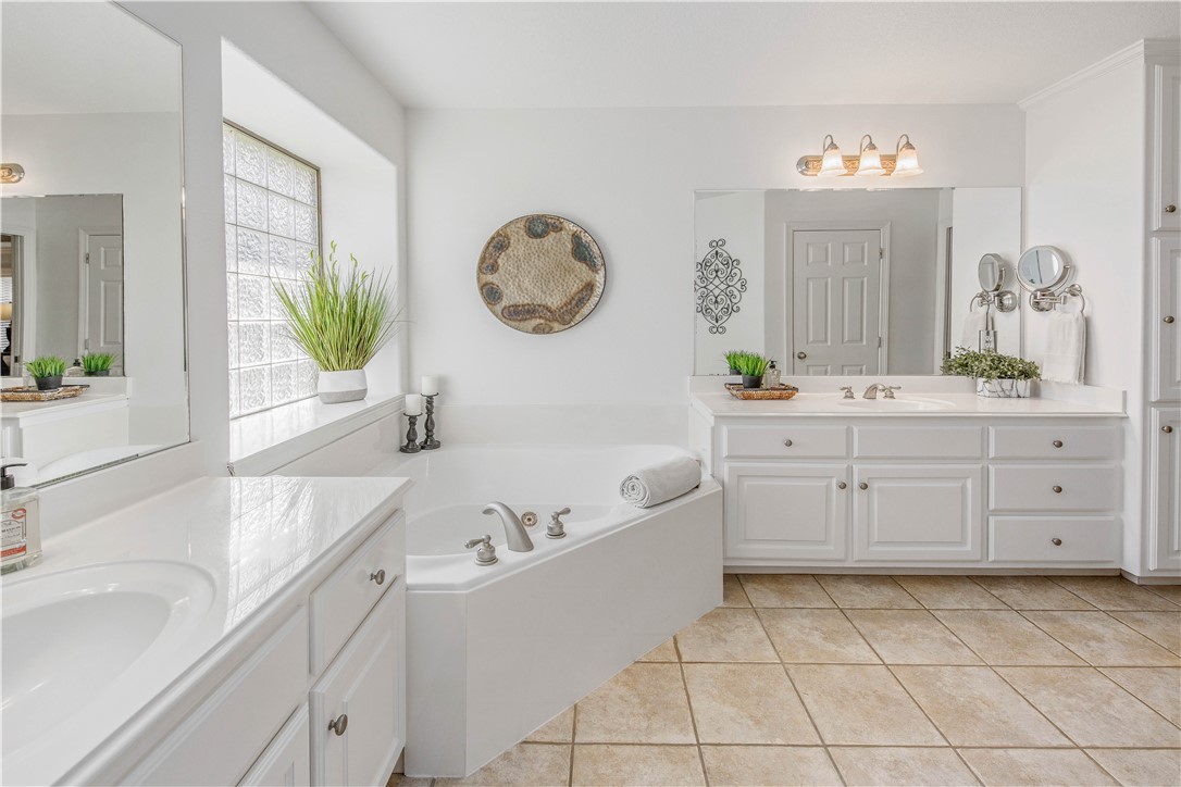 406 Cold Spring Drive College Station, TX 77845 - Photo 18 of 32 a spacious bathroom with a tub sink and mirror