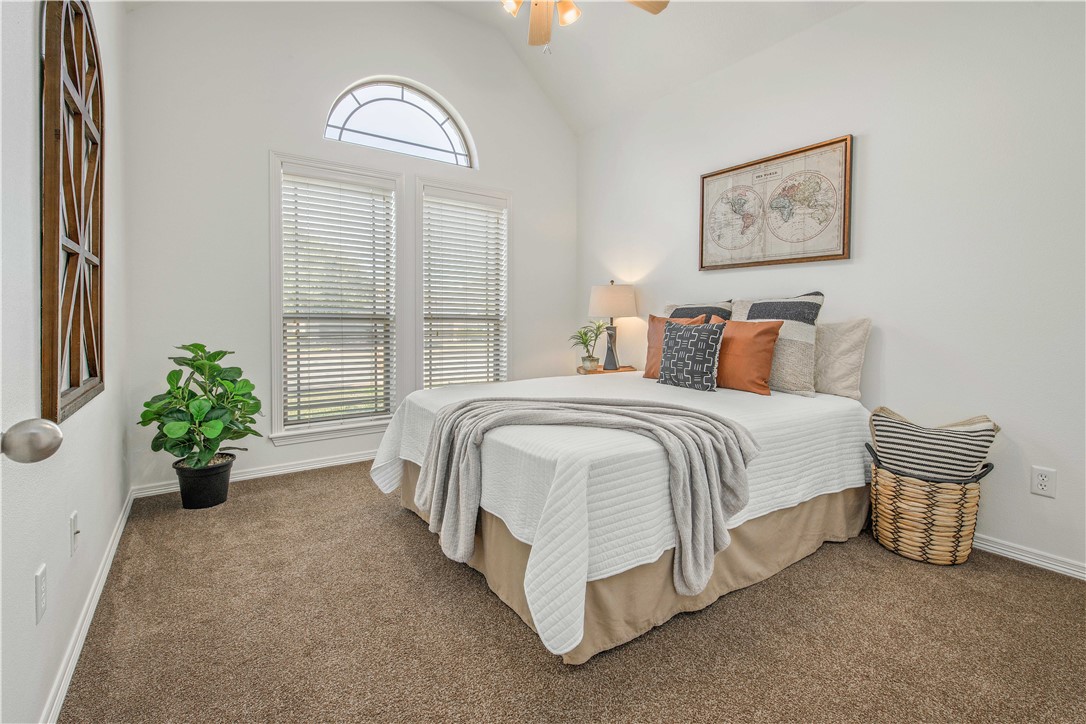 406 Cold Spring Drive College Station, TX 77845 - Photo 19 of 32 a spacious bedroom with a bed and potted plant