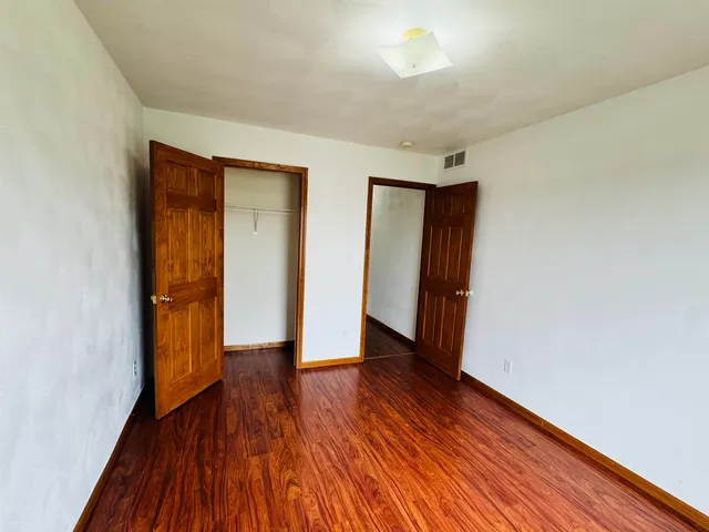 a view of a room with wooden floor and staircase