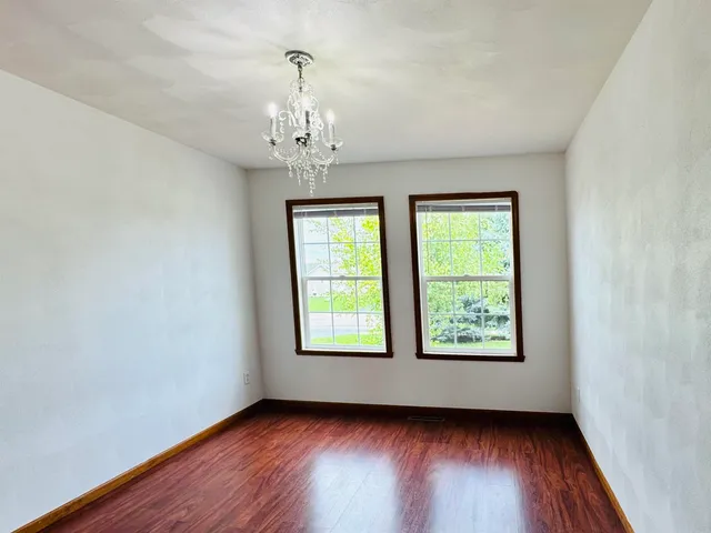a bathroom with a granite countertop toilet sink and mirror