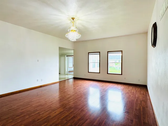 a view of an empty room and wooden floor
