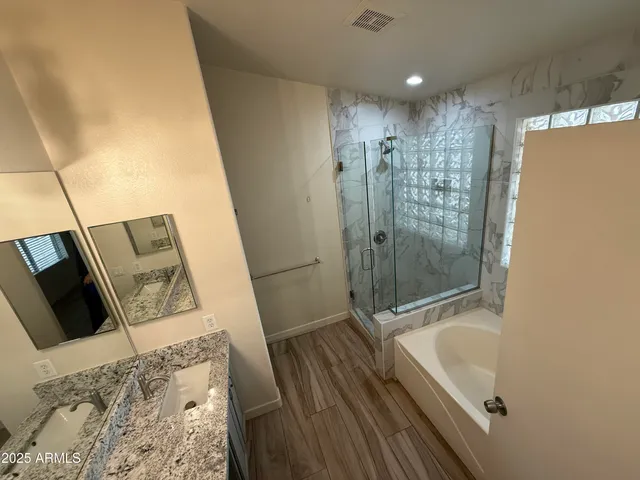 a bathroom with a bathtub and a shower