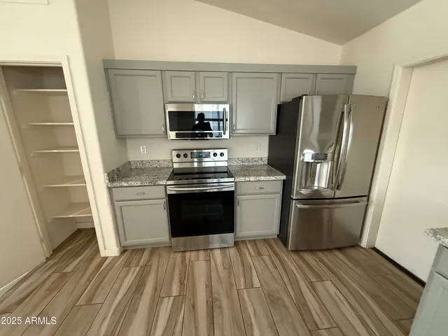 a kitchen with a refrigerator stove and sink