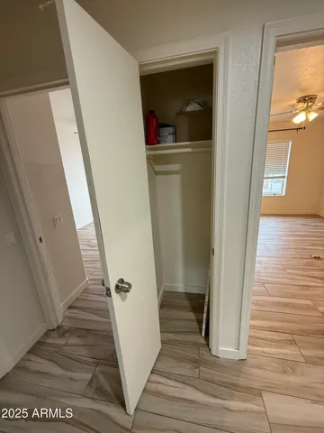 a view of a hallway view with wooden floor and staircase