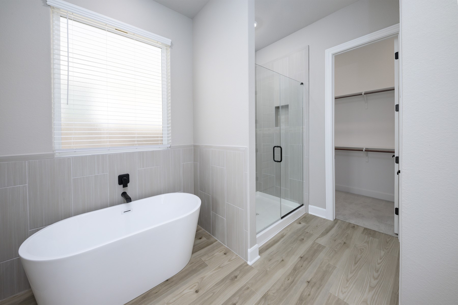 10622 Sutter Crk Drive Rosharon, TX 77583 - Photo 12 of 28 This master ensuite showcases a stunning standalone soaking tub, a separate glass-enclosed walk-in shower with designer tile, and a seamless flow into the massive walk-in closet.