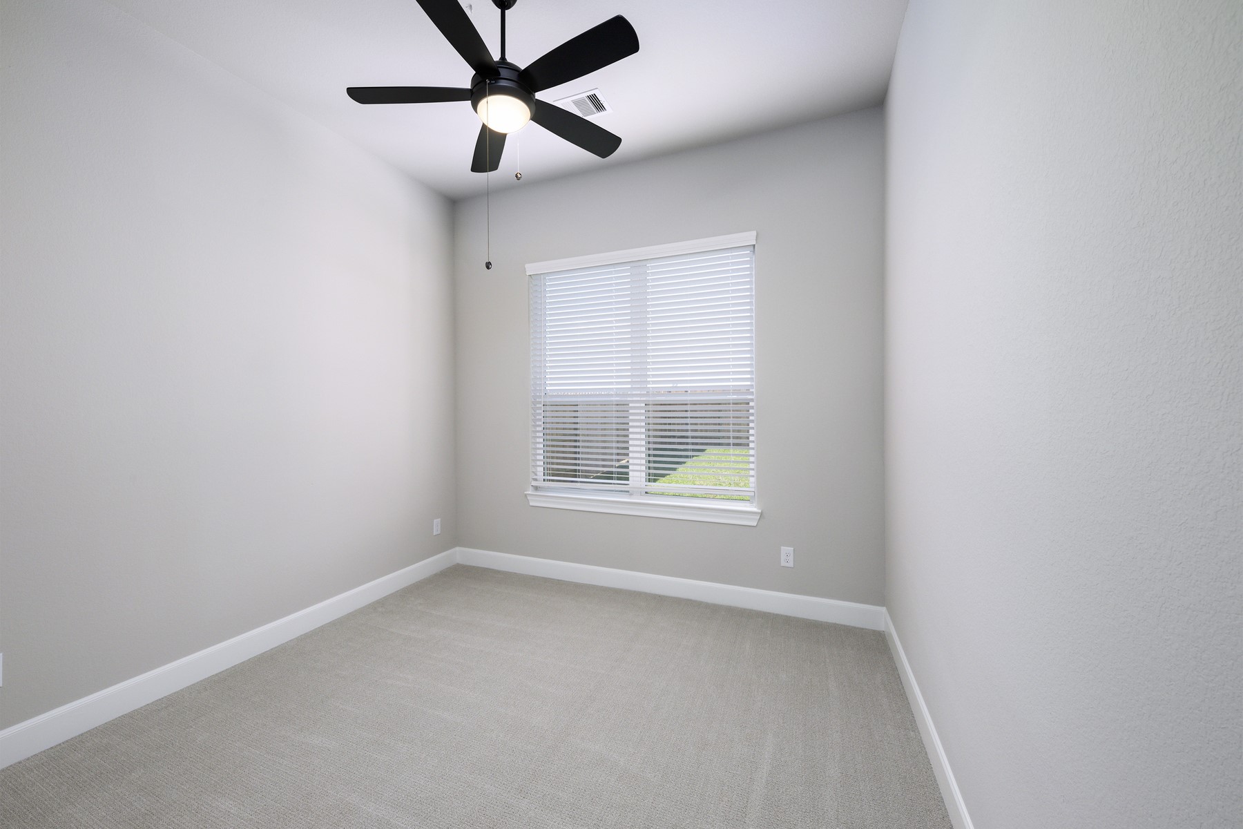 10622 Sutter Crk Drive Rosharon, TX 77583 - Photo 14 of 28 Secondary Bedroom 1 offers a clean, neutral palette and soft carpeting, making it an ideal space for a cozy guest room, a bright nursery, or a quiet home office.