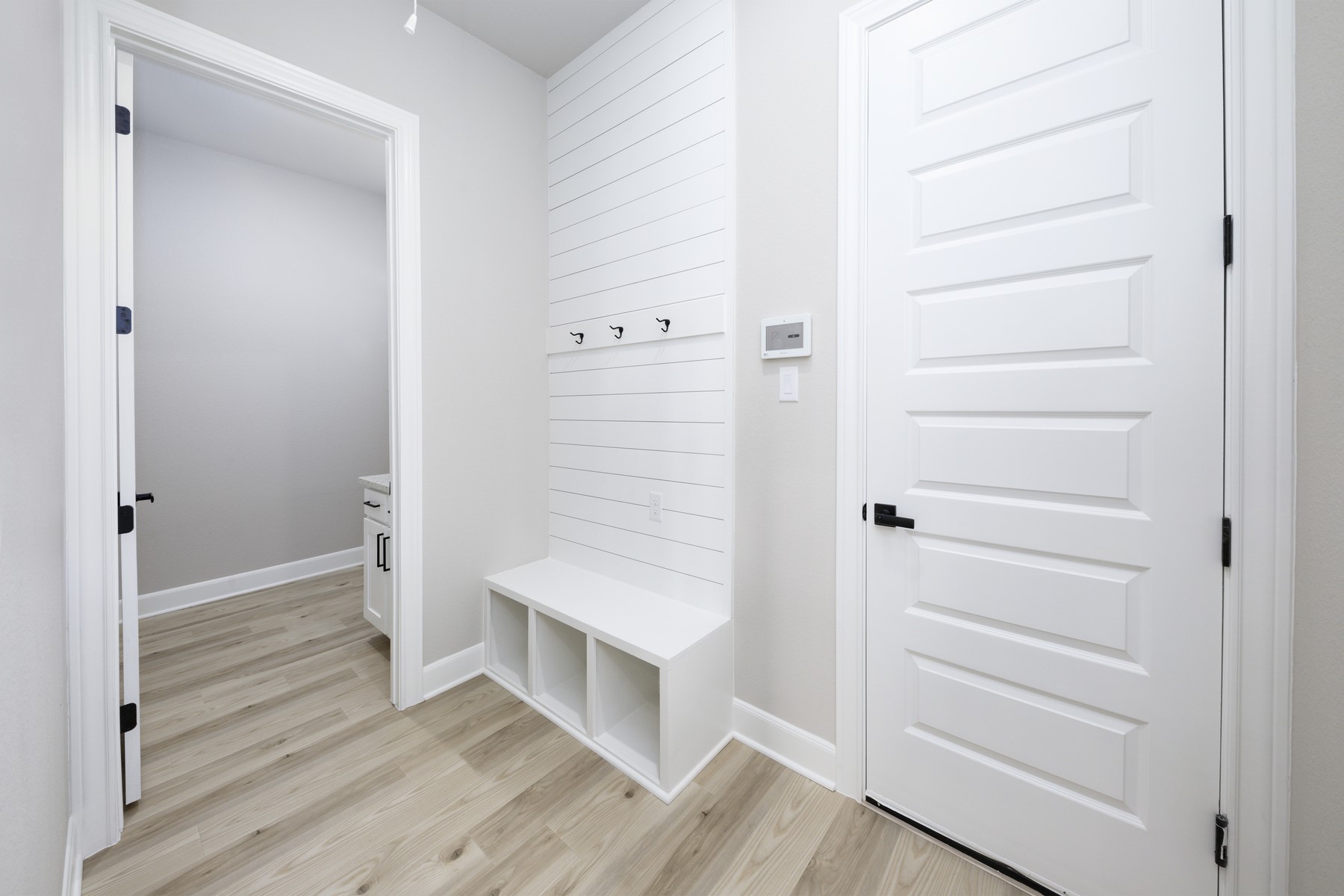 10622 Sutter Crk Drive Rosharon, TX 77583 - Photo 3 of 28 Stay organized in style with this built-in mudroom nook, featuring custom shiplap detailing, storage cubbies, and sleek black hardware—the perfect "drop zone" for a busy household.