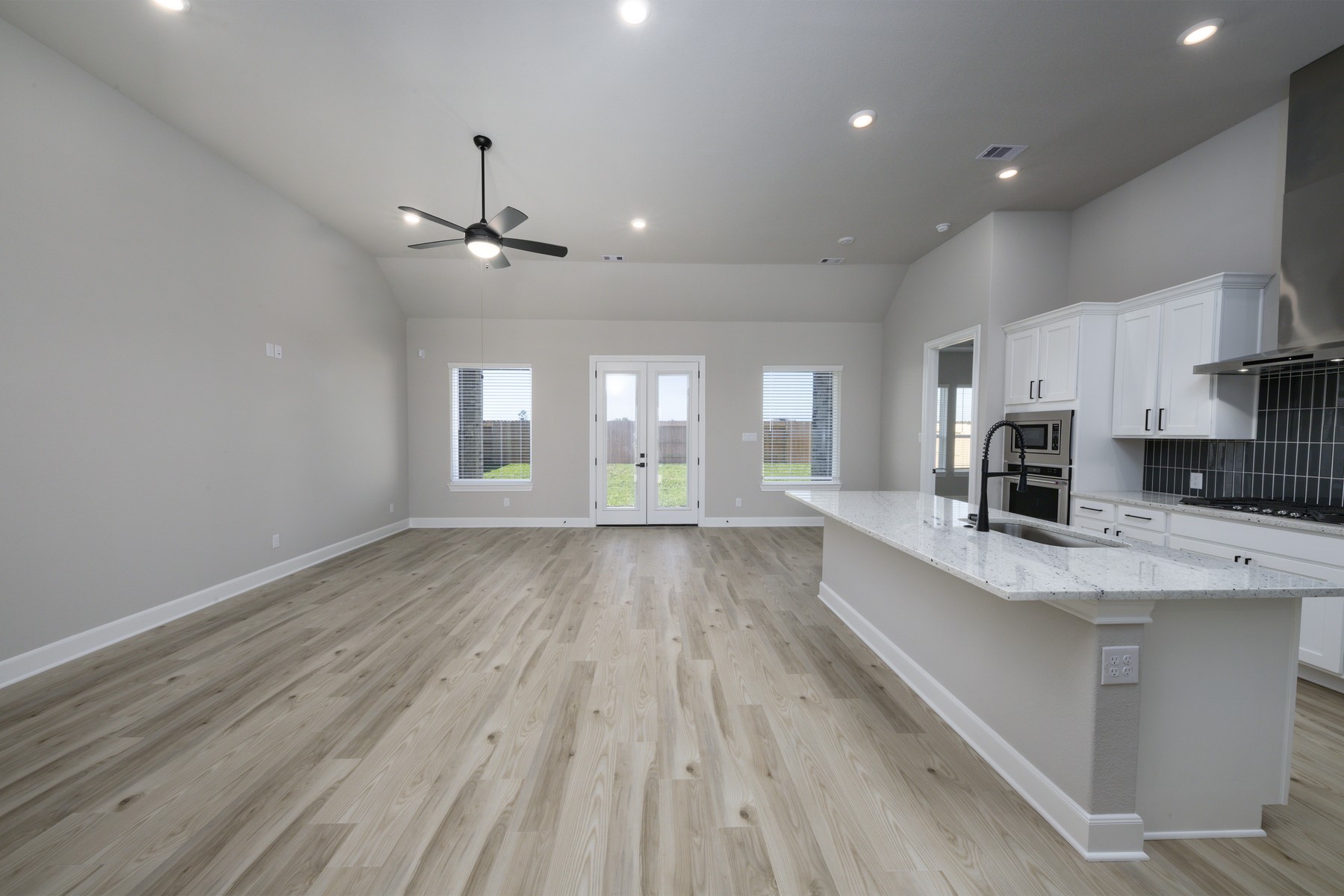 10622 Sutter Crk Drive Rosharon, TX 77583 - Photo 6 of 28 Elegant French doors provide a seamless transition to the backyard, while the high-pitched ceiling and recessed lighting ensure every corner of this grand living space feels bright and boundless.