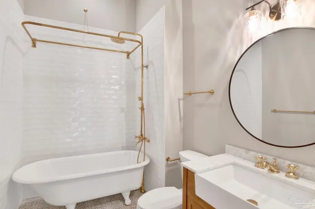 a bathroom with a sink toilet and a mirror