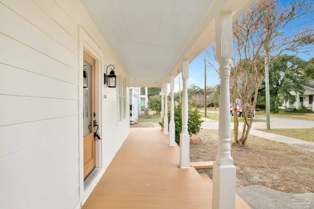 a view of a porch with wooden floor and fence