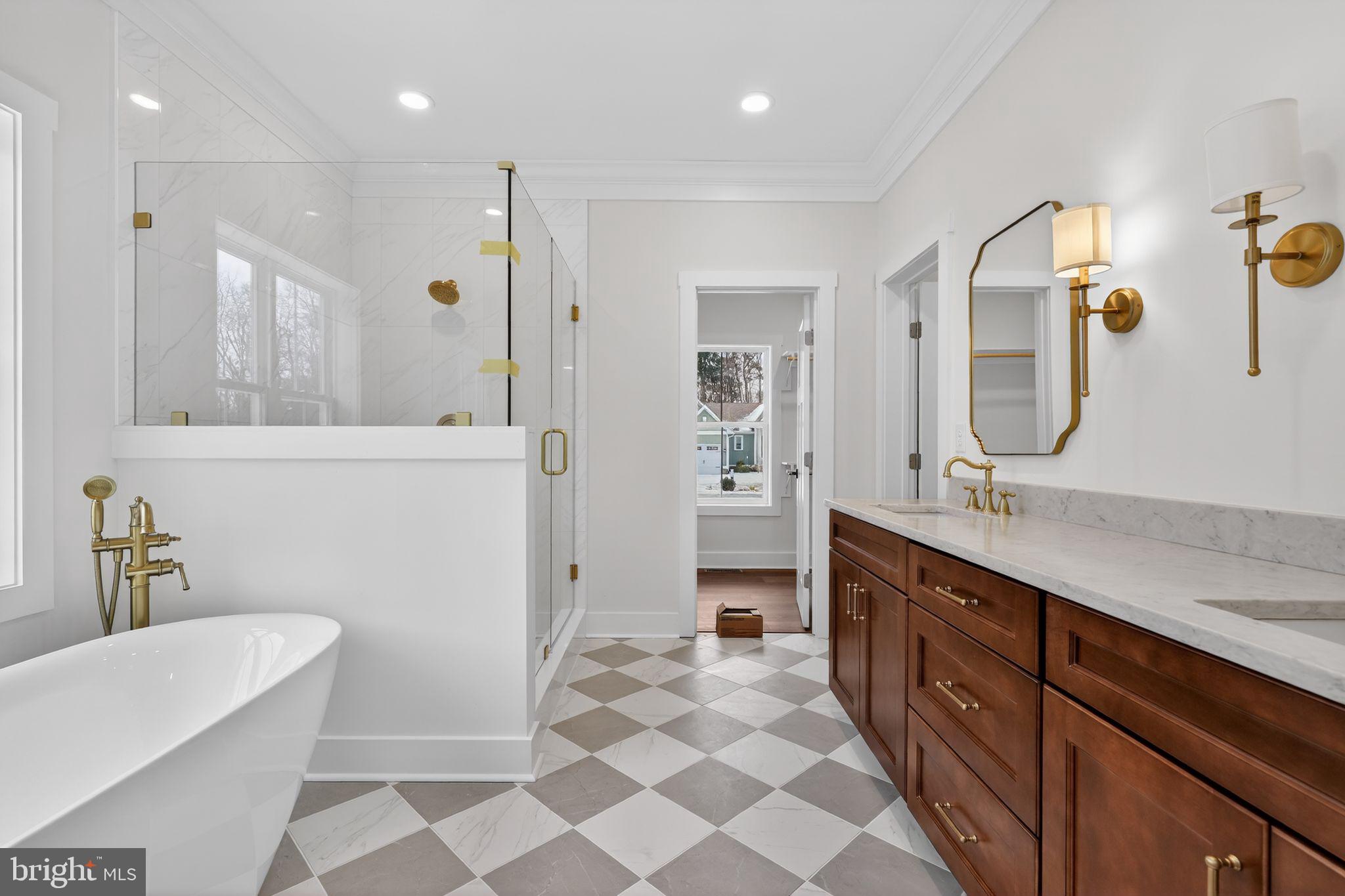 27458 Mooring Way Salisbury, MD 21801 - Photo 18 of 32 a spacious bathroom with a double vanity sink a mirror and a shower