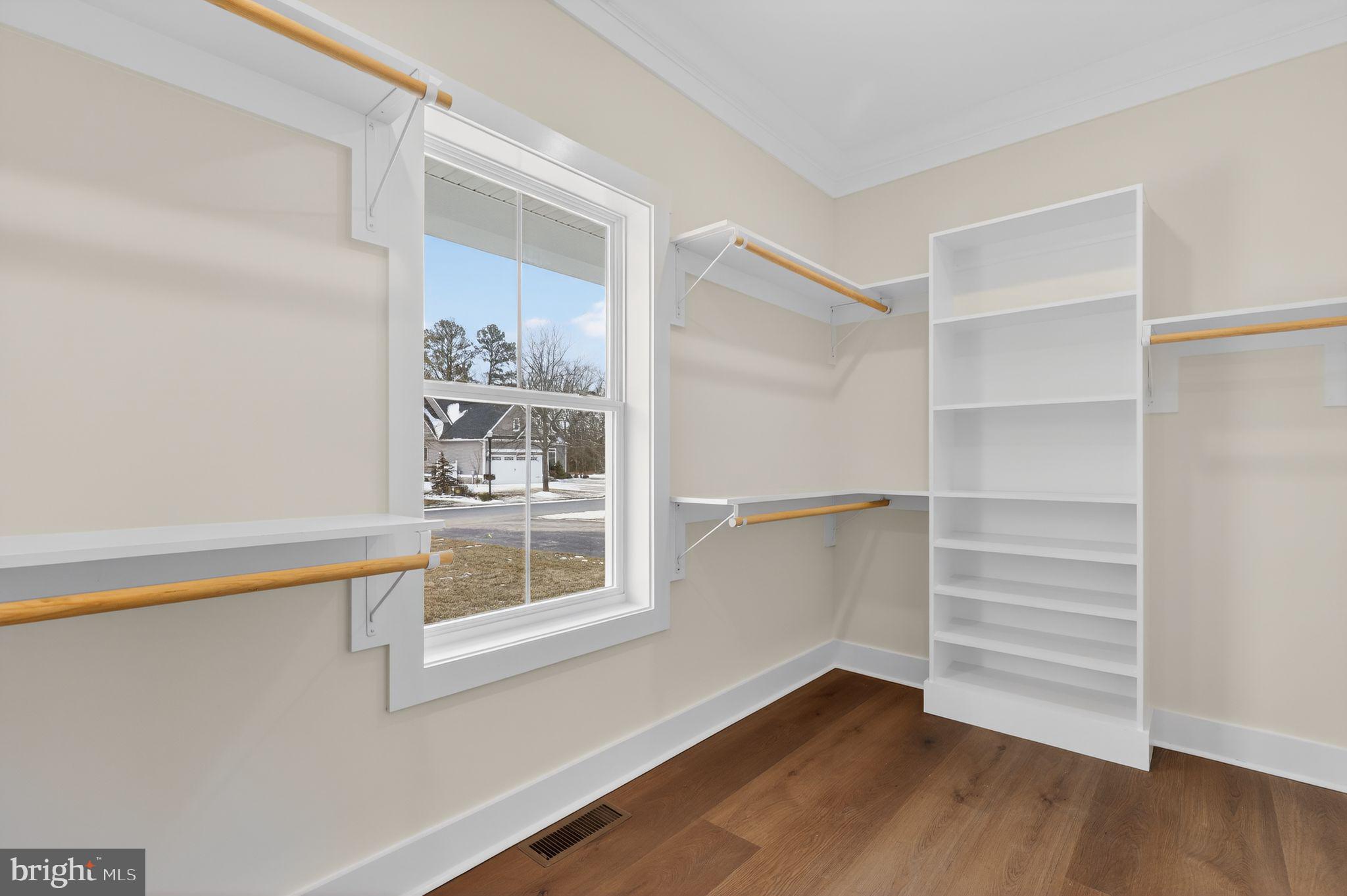 27458 Mooring Way Salisbury, MD 21801 - Photo 19 of 32 a view of an empty room with a window and wooden floor