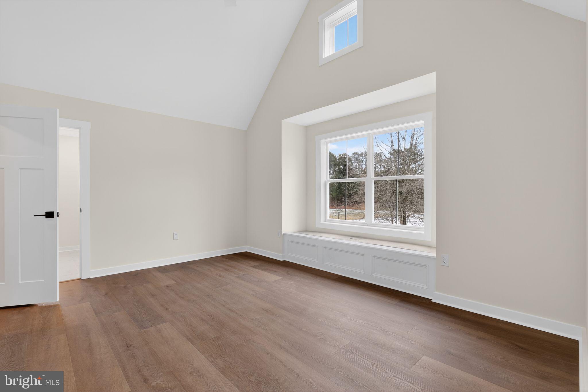 27458 Mooring Way Salisbury, MD 21801 - Photo 21 of 32 an empty room with wooden floor and windows