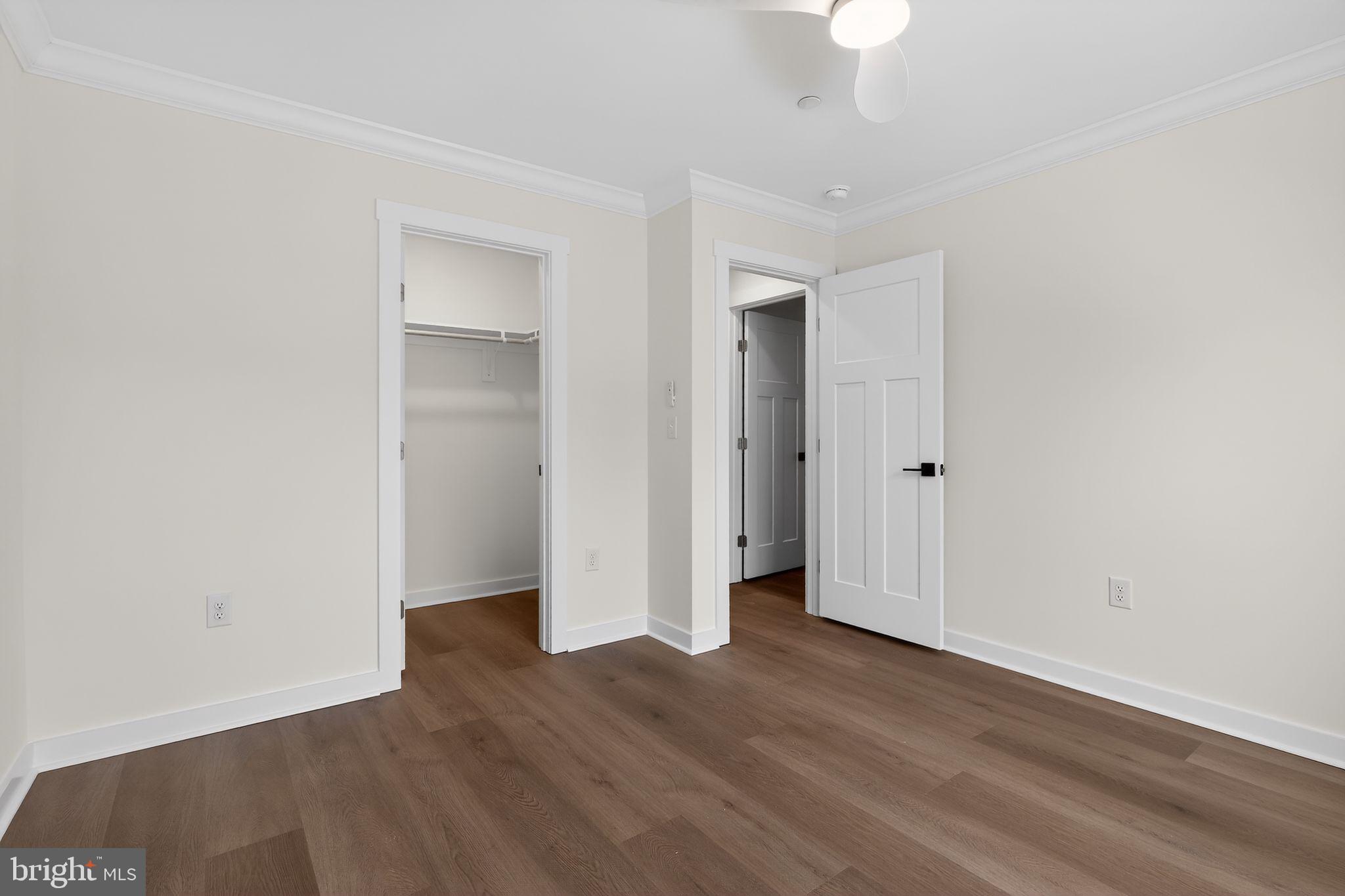 27458 Mooring Way Salisbury, MD 21801 - Photo 24 of 32 an empty room with wooden floor and a ceiling fan