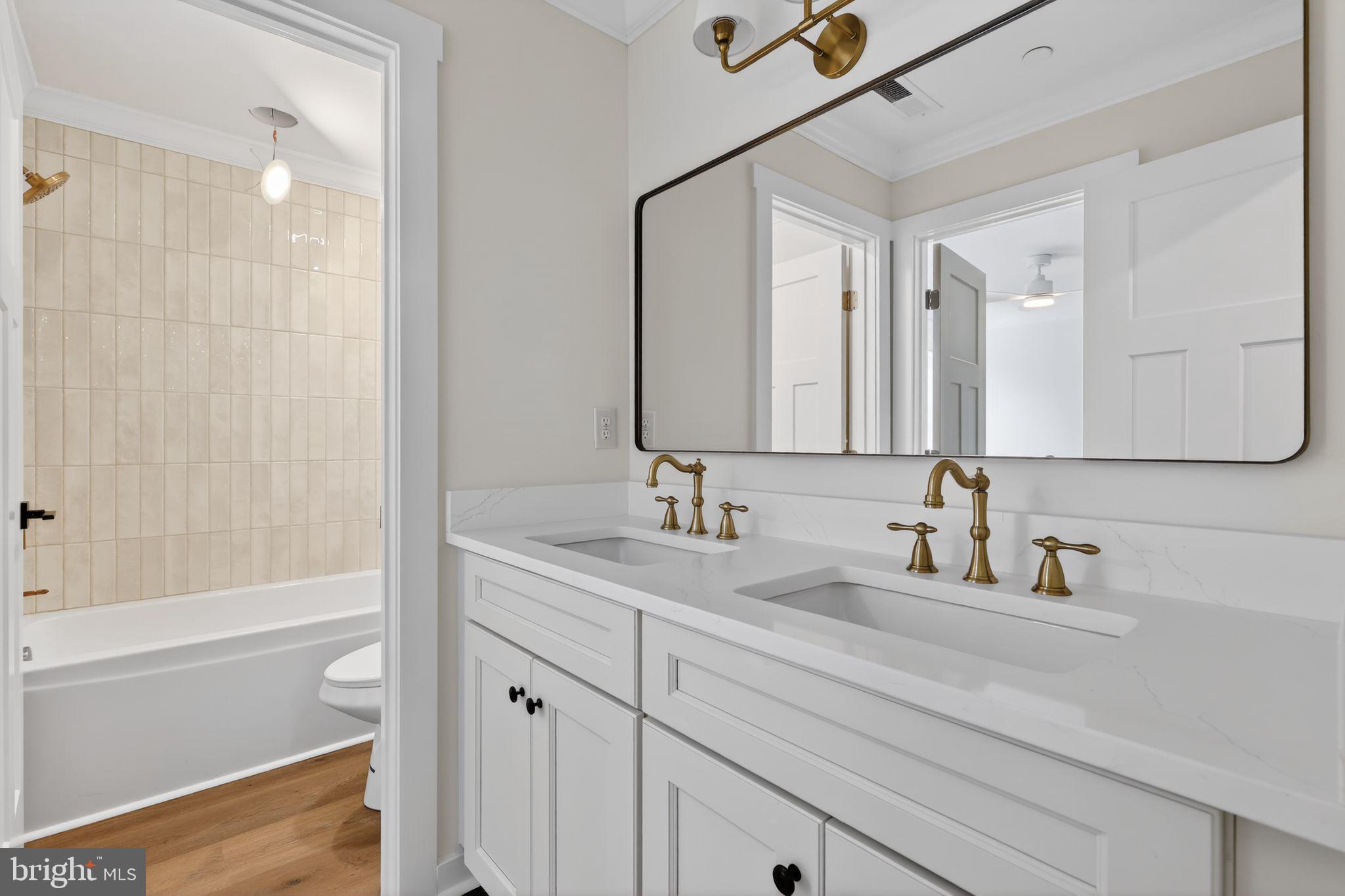 27458 Mooring Way Salisbury, MD 21801 - Photo 29 of 32 a bathroom with a double vanity sink and a mirror