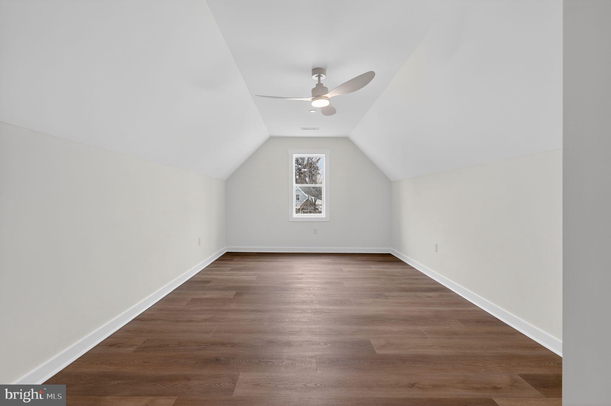 27458 Mooring Way Salisbury, MD 21801 - Photo 31 of 32 an empty room with wooden floor ceiling fan and windows