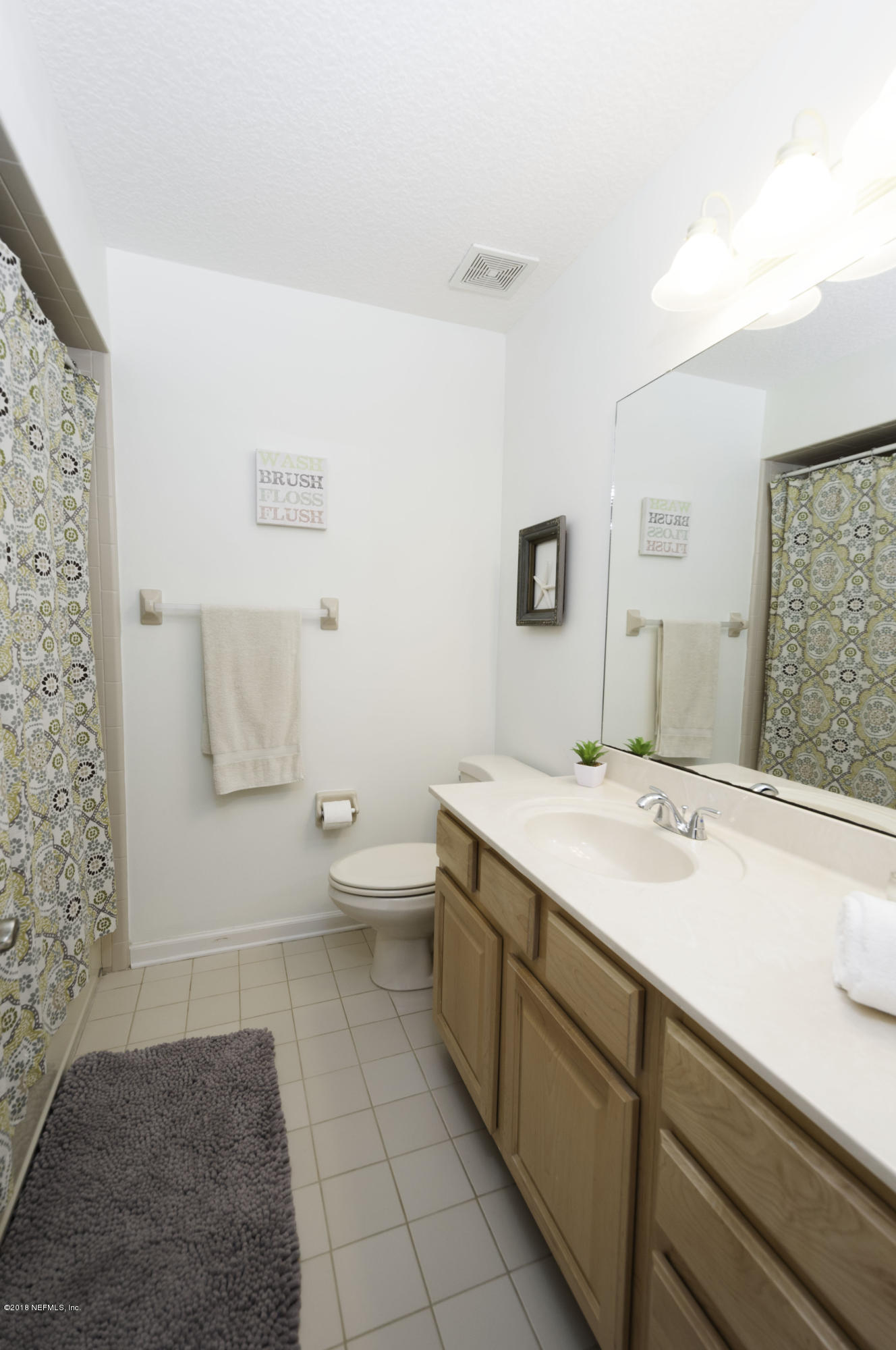 1341 Roberts Road St. Johns, FL 32259 - Photo 24 of 36 a spacious bathroom with a sink a toilet and a mirror