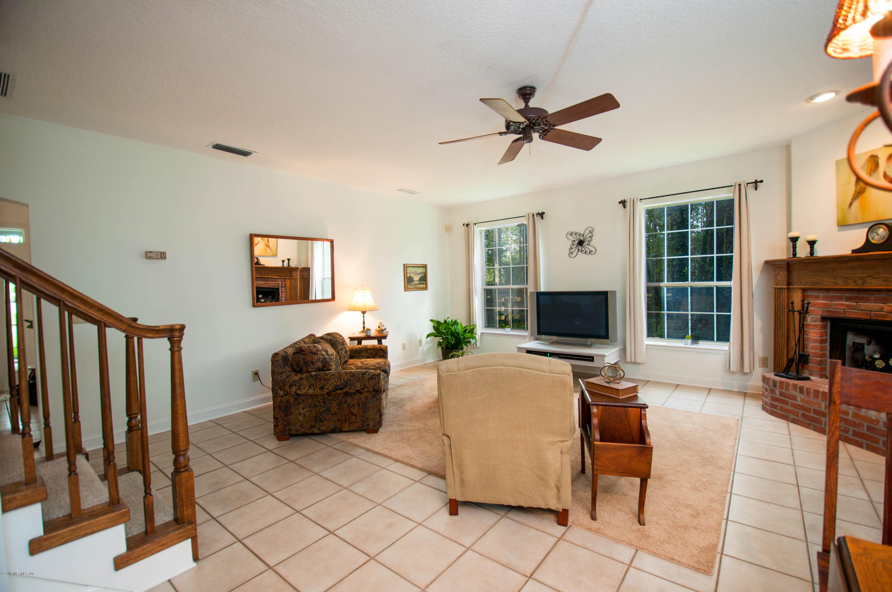 1341 Roberts Road St. Johns, FL 32259 - Photo 7 of 36 a living room with furniture a fireplace and a flat screen tv
