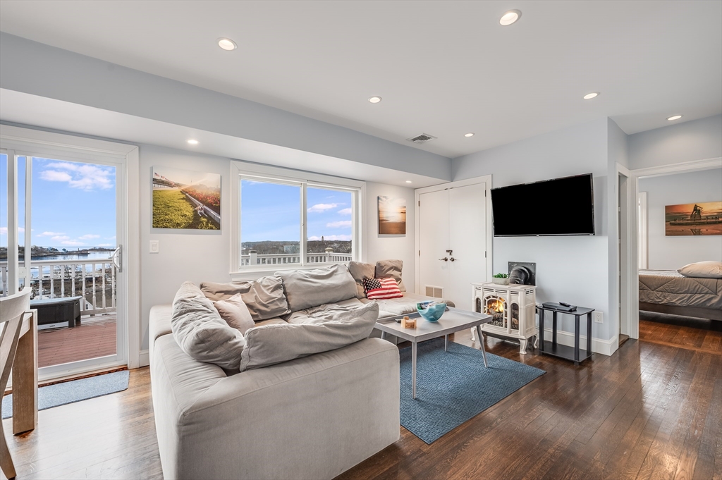 17 Silva Court, Unit 3 Gloucester, MA 01930 - Photo 1 of 22 a living room with furniture and a flat screen tv
