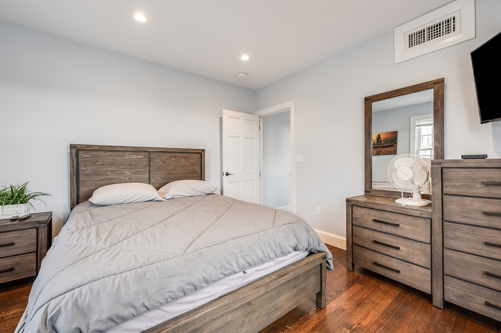 17 Silva Court, Unit 3 Gloucester, MA 01930 - Photo 19 of 22 a bedroom with a bed and a flat screen tv