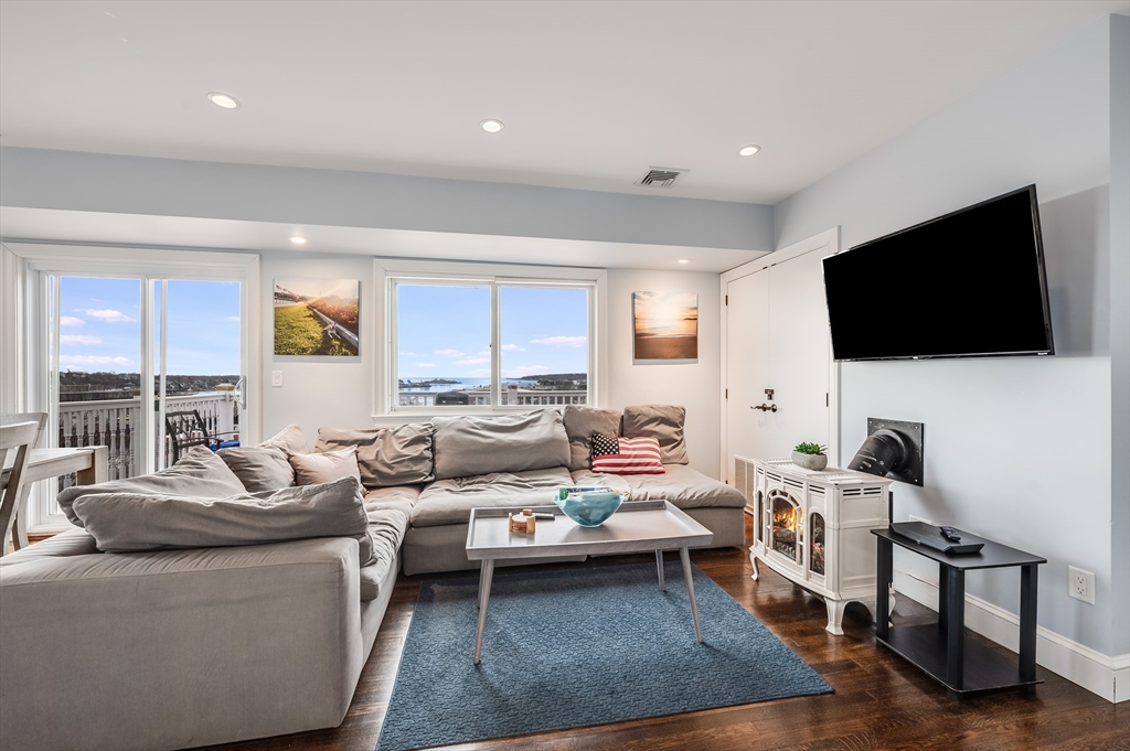 17 Silva Court, Unit 3 Gloucester, MA 01930 - Photo 2 of 22 a living room with furniture and a flat screen tv