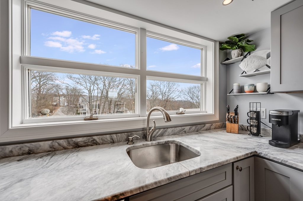 17 Silva Court, Unit 3 Gloucester, MA 01930 - Photo 6 of 22 a kitchen with a granite countertop sink and natural light