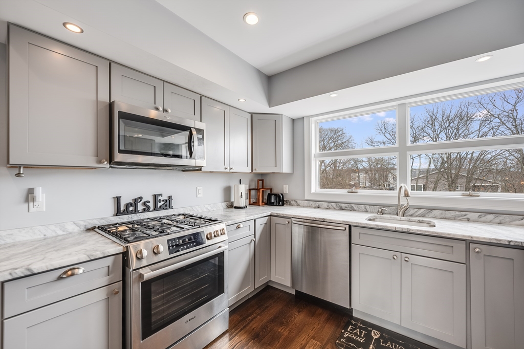 17 Silva Court, Unit 3 Gloucester, MA 01930 - Photo 7 of 22 a kitchen with stainless steel appliances white cabinets appliances a sink and a window