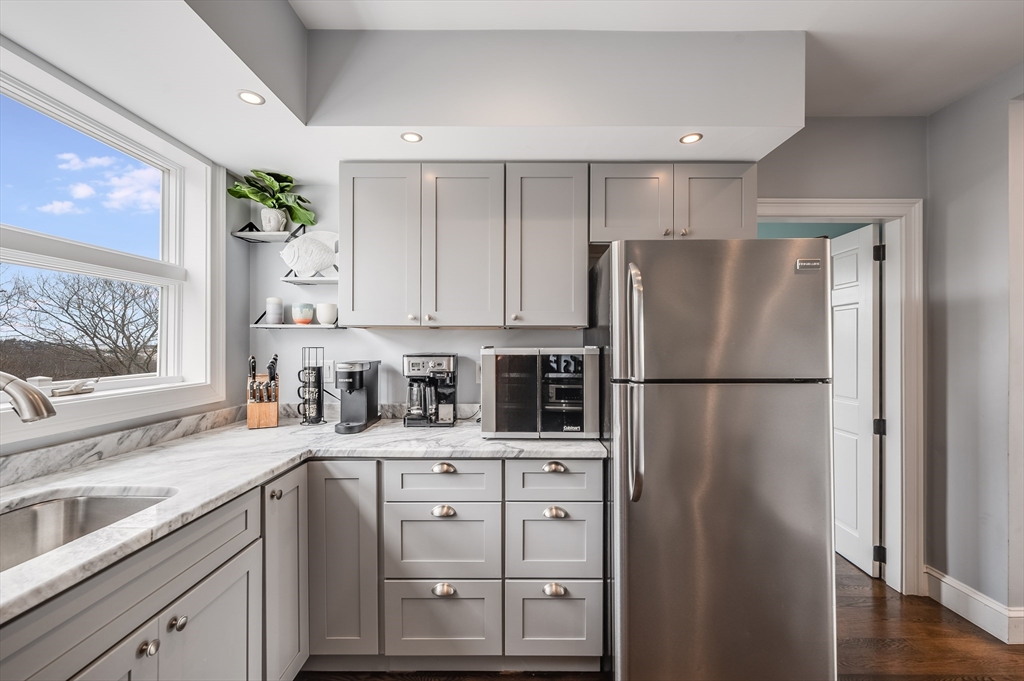 17 Silva Court, Unit 3 Gloucester, MA 01930 - Photo 8 of 22 a kitchen with stainless steel appliances a refrigerator sink and cabinets