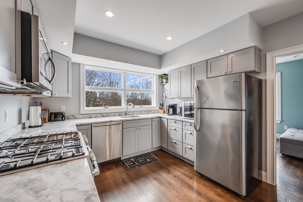 17 Silva Court, Unit 3 Gloucester, MA 01930 - Photo 9 of 22 a kitchen with stainless steel appliances granite countertop a refrigerator stove and sink