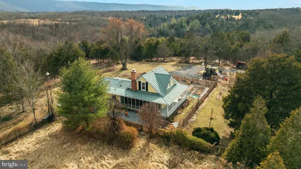 a view of a house with a yard and mountain