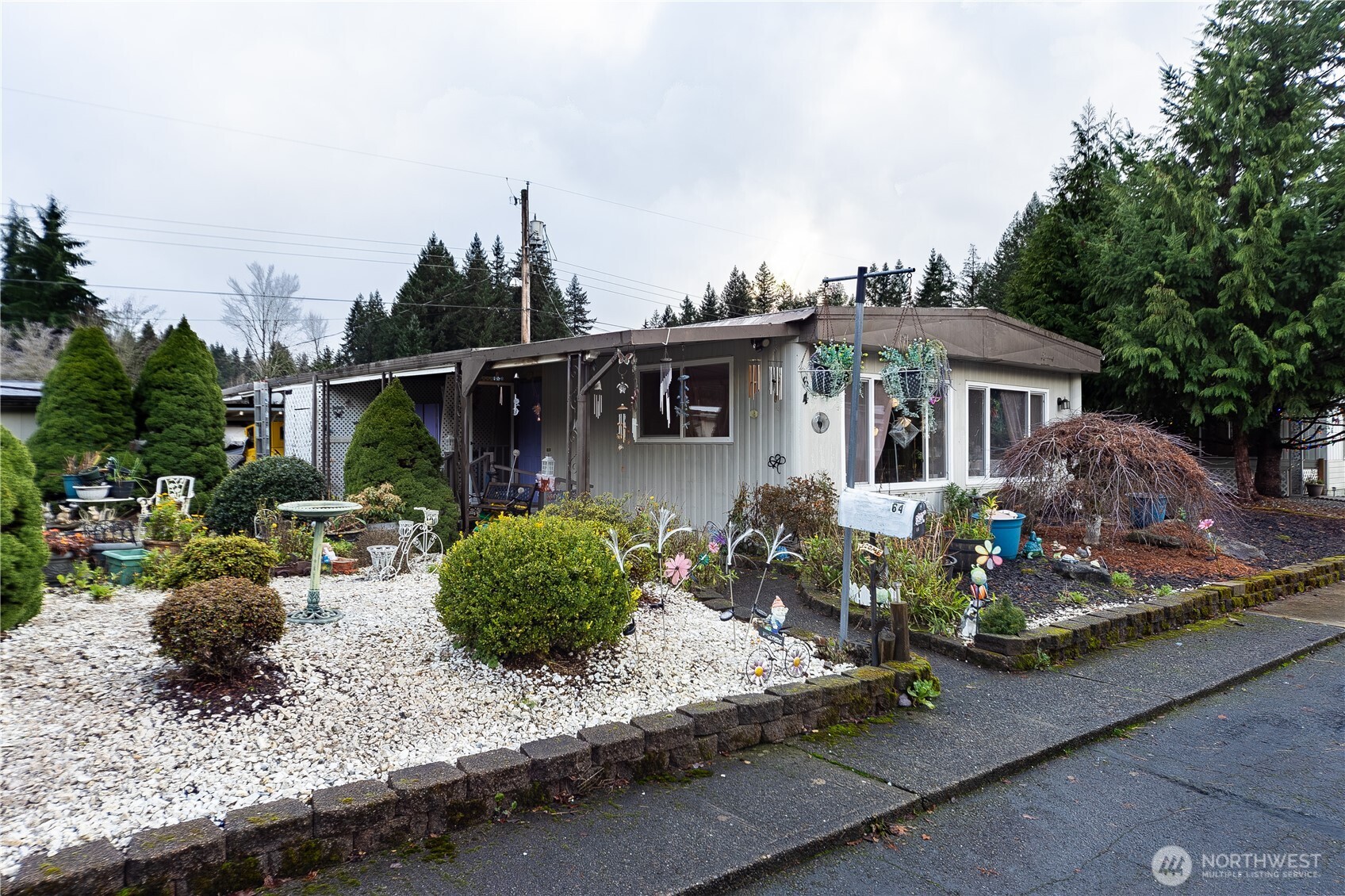 930 Trosper Road Southwest, Unit 64 Tumwater, WA 98512 - Photo 1 of 26 a view of a house with backyard and garden