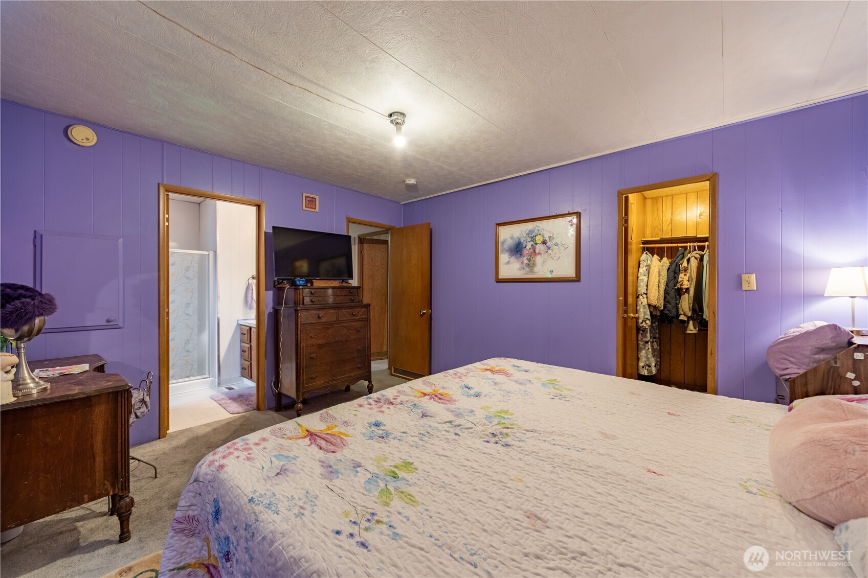 930 Trosper Road Southwest, Unit 64 Tumwater, WA 98512 - Photo 14 of 26 a bedroom with a bed and a flat screen tv