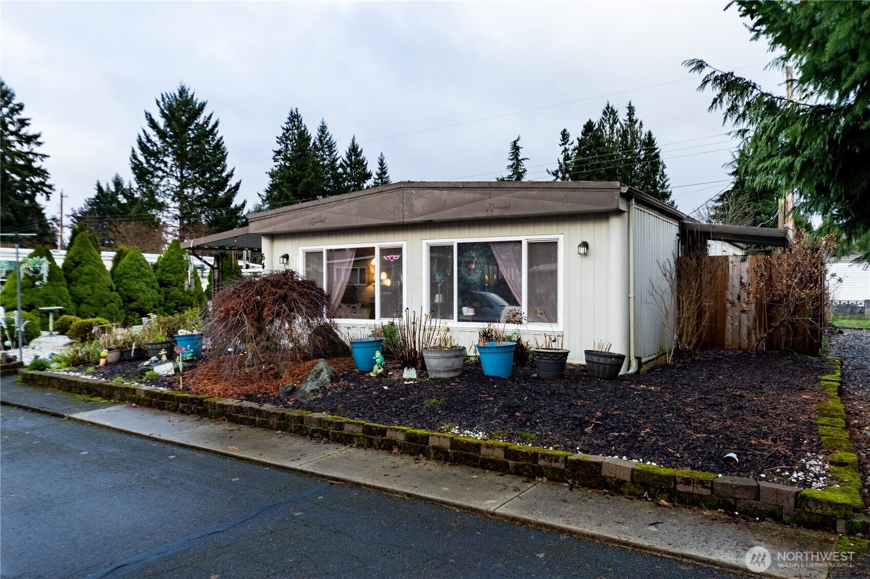 930 Trosper Road Southwest, Unit 64 Tumwater, WA 98512 - Photo 2 of 26 a front view of a house with a garden
