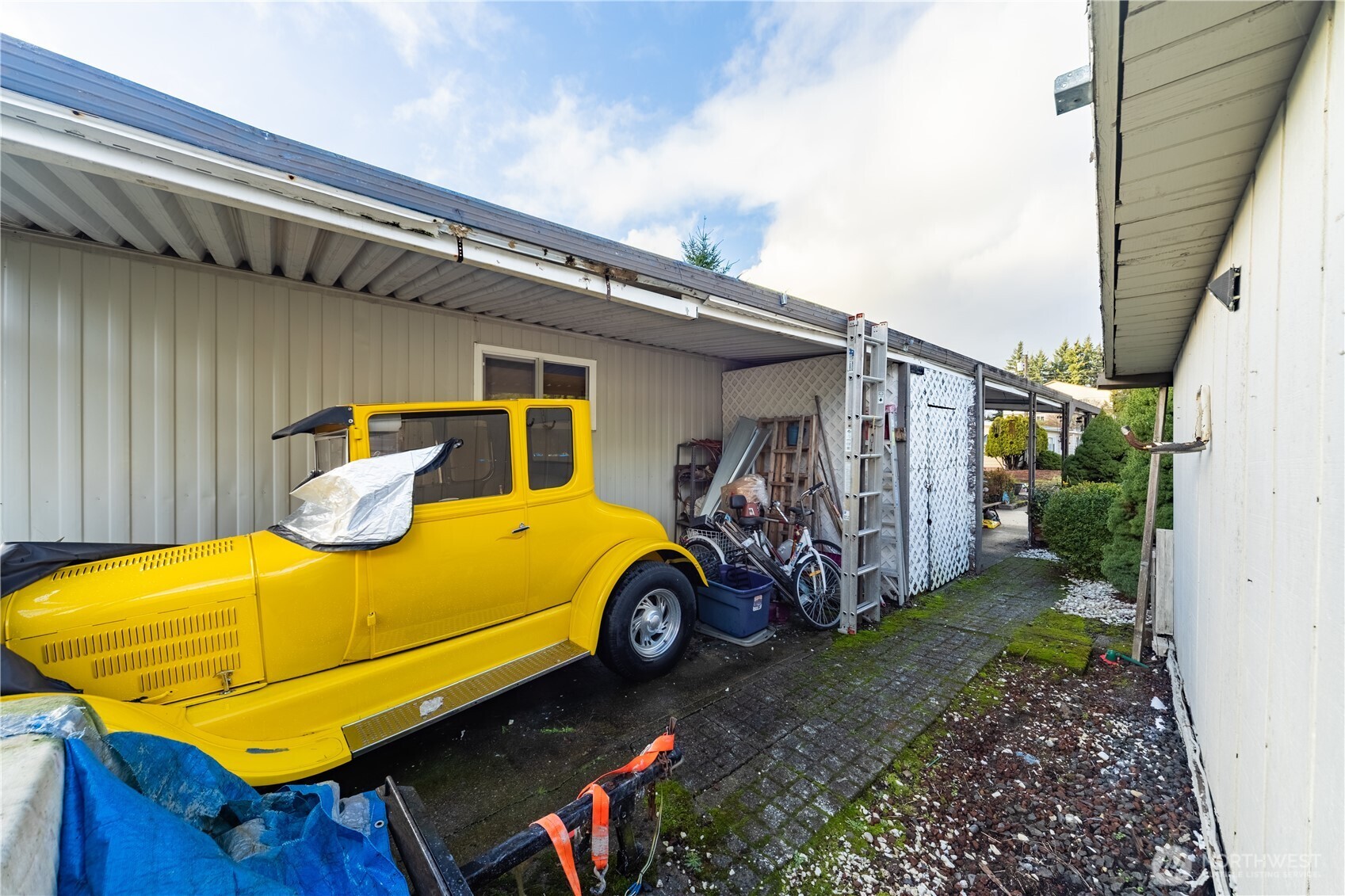 930 Trosper Road Southwest, Unit 64 Tumwater, WA 98512 - Photo 24 of 26 a blue house with trees in front of it
