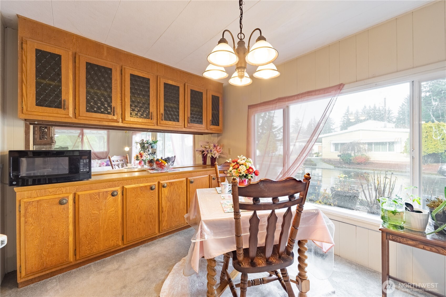 930 Trosper Road Southwest, Unit 64 Tumwater, WA 98512 - Photo 8 of 26 a view of a dining room with furniture a chandelier and large windows