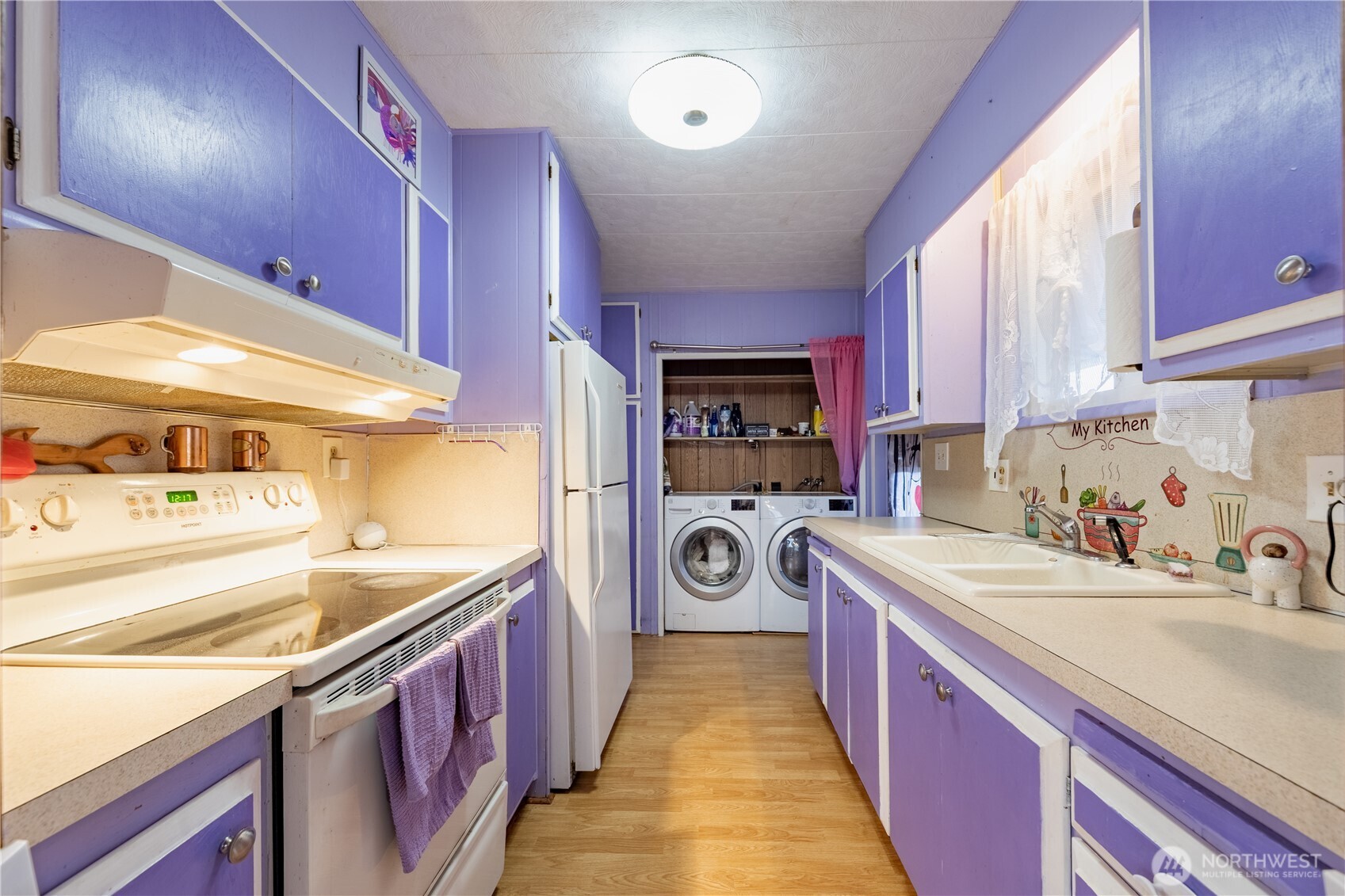 930 Trosper Road Southwest, Unit 64 Tumwater, WA 98512 - Photo 9 of 26 a kitchen with a sink a stove and a refrigerator