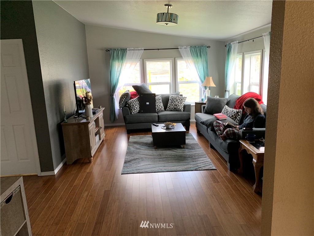 11315 Angeline Road East Bonney Lake, WA 98391 - Photo 2 of 14 a living room with furniture and a flat screen tv