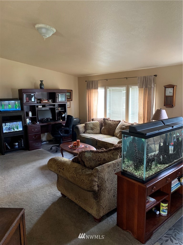 11315 Angeline Road East Bonney Lake, WA 98391 - Photo 4 of 14 a living room with furniture and a flat screen tv