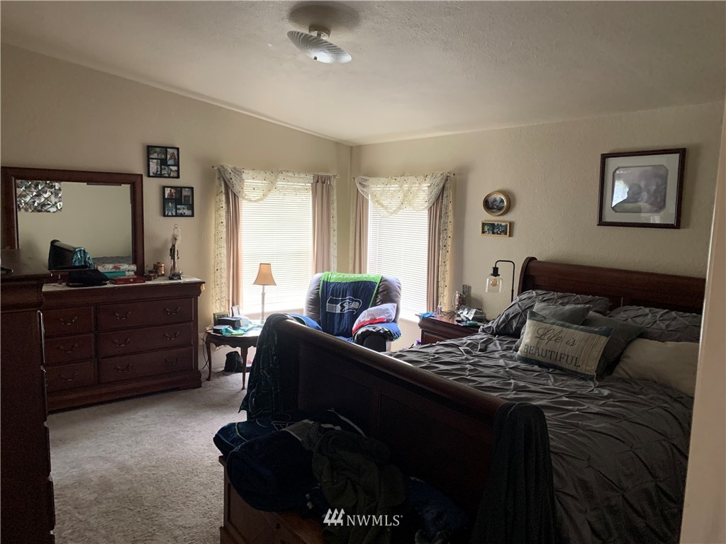 11315 Angeline Road East Bonney Lake, WA 98391 - Photo 5 of 14 a bedroom with a bed and wooden floor