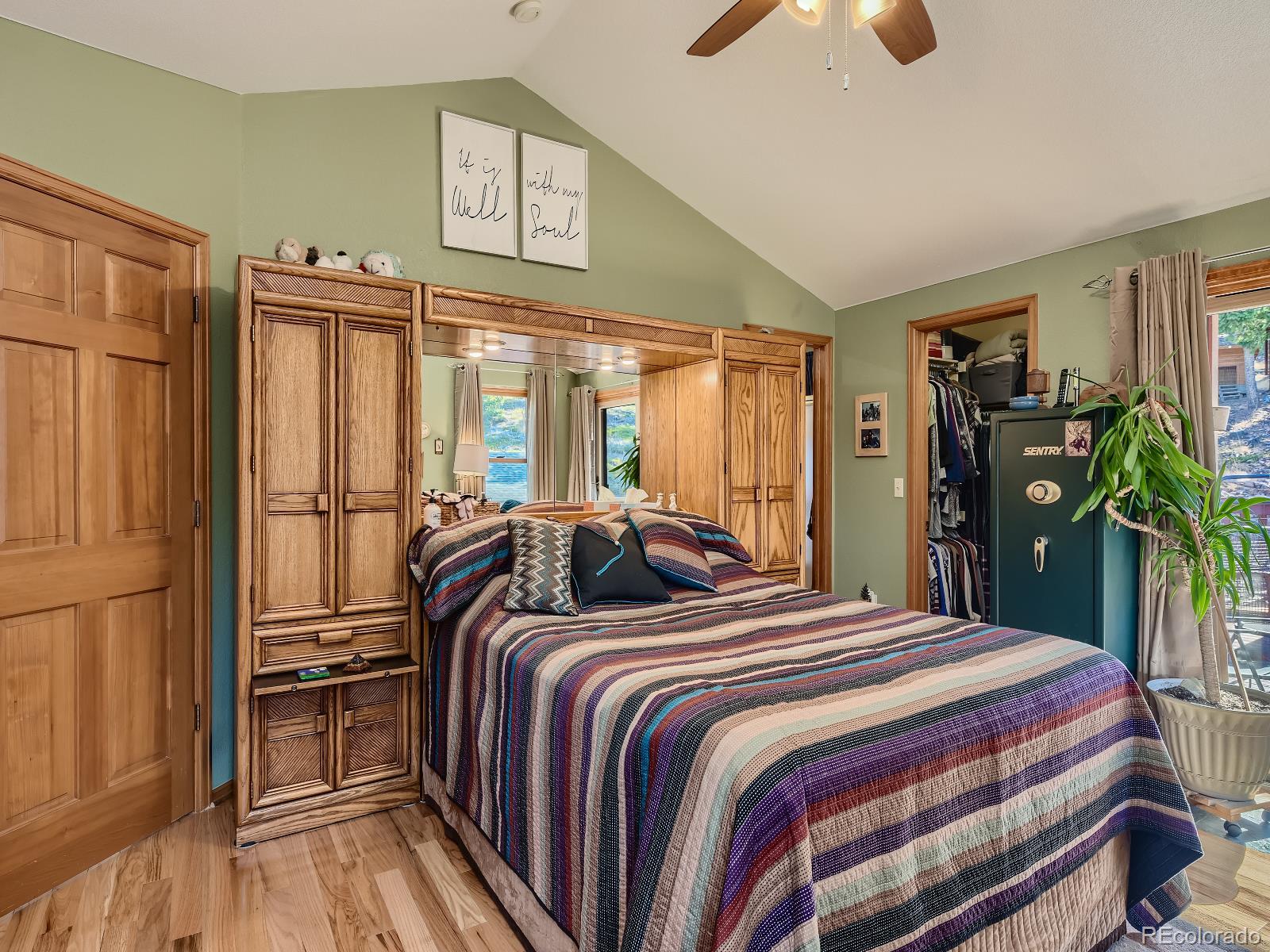 7051 Ski Trail Evergreen, CO 80439 - Photo 15 of 39 a bedroom with a bed and a chandelier