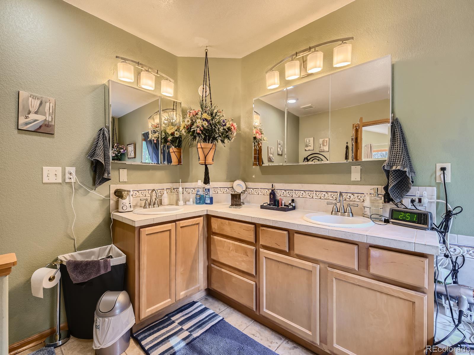 7051 Ski Trail Evergreen, CO 80439 - Photo 16 of 39 a bathroom with a sink and a mirror