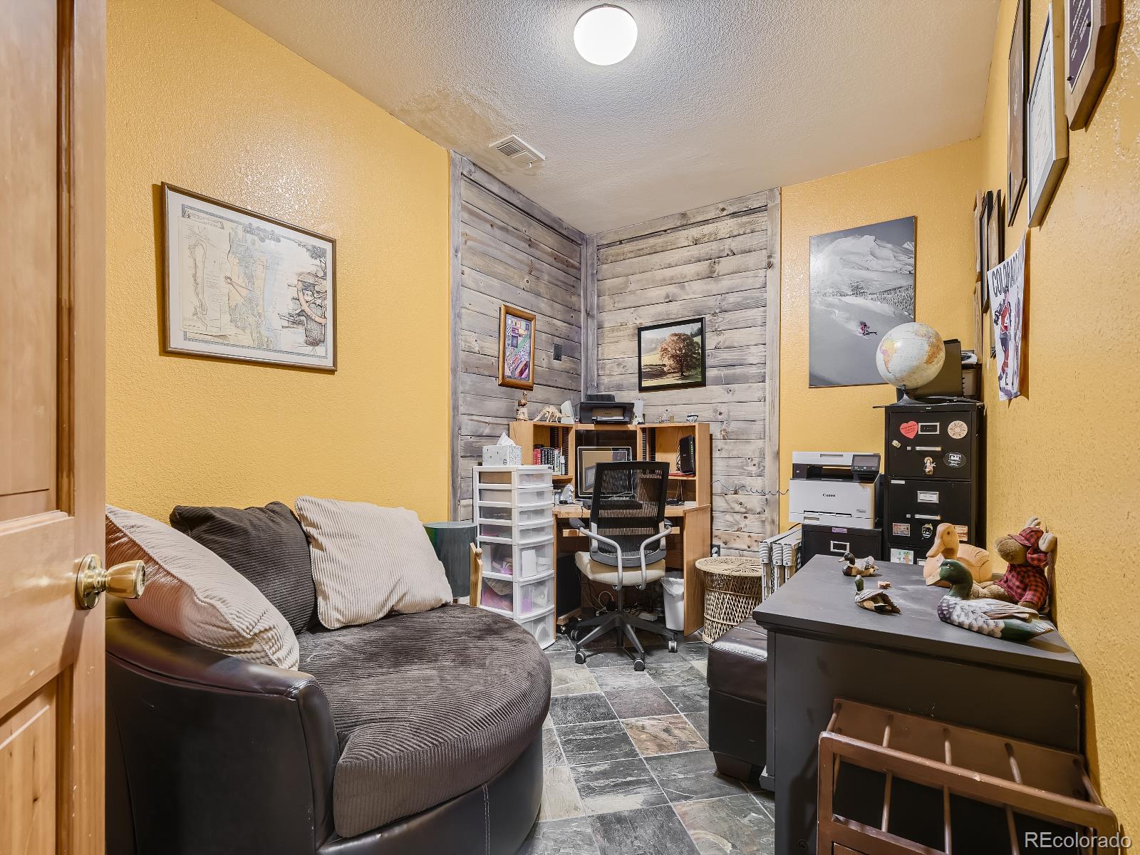 7051 Ski Trail Evergreen, CO 80439 - Photo 20 of 39 a living room with furniture and a flat screen tv