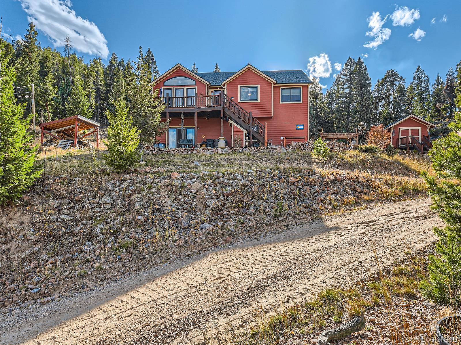 7051 Ski Trail Evergreen, CO 80439 - Photo 25 of 39 a front view of a house with a yard and garage