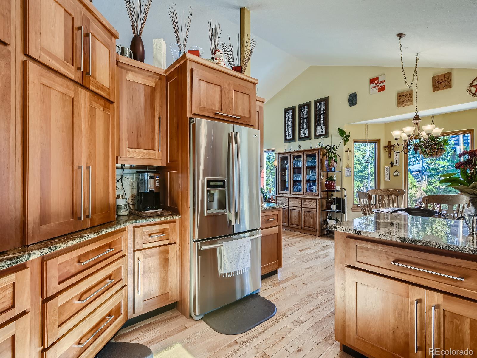 7051 Ski Trail Evergreen, CO 80439 - Photo 3 of 39 a kitchen with stainless steel appliances a refrigerator and a stove