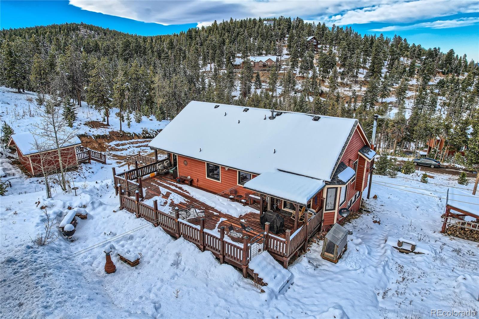 7051 Ski Trail Evergreen, CO 80439 - Photo 34 of 39 a view of a roof deck with chair and wooden fence