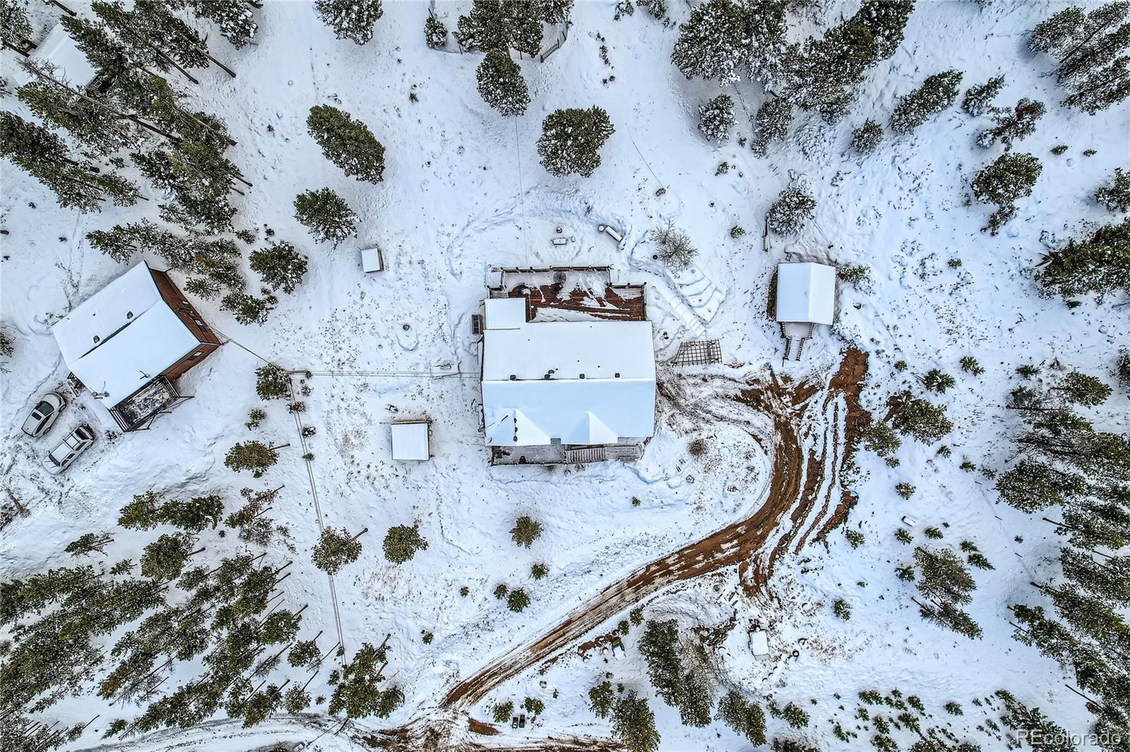 7051 Ski Trail Evergreen, CO 80439 - Photo 39 of 39 an aerial view of a fireplace with wooden floor