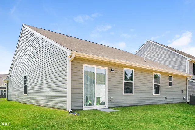a view of a house with a backyard