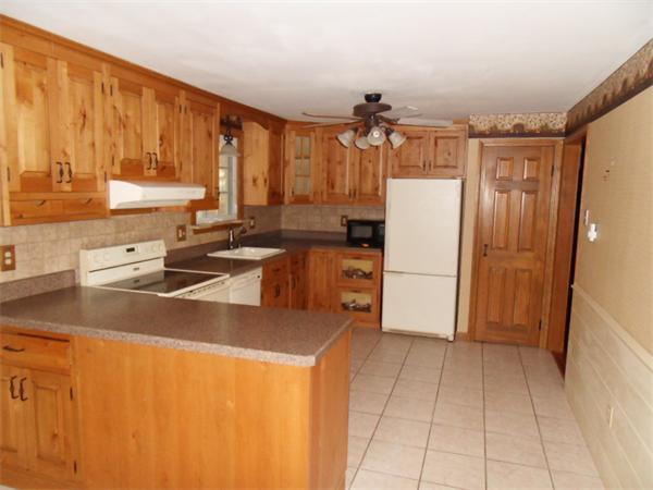 650 Fowler Road Northbridge, MA 01534 - Photo 7 of 15 a kitchen with stainless steel appliances granite countertop a refrigerator a stove and a sink with wooden cabinets